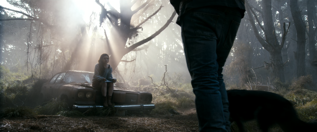 Mia sits on a familiar-looking junker 